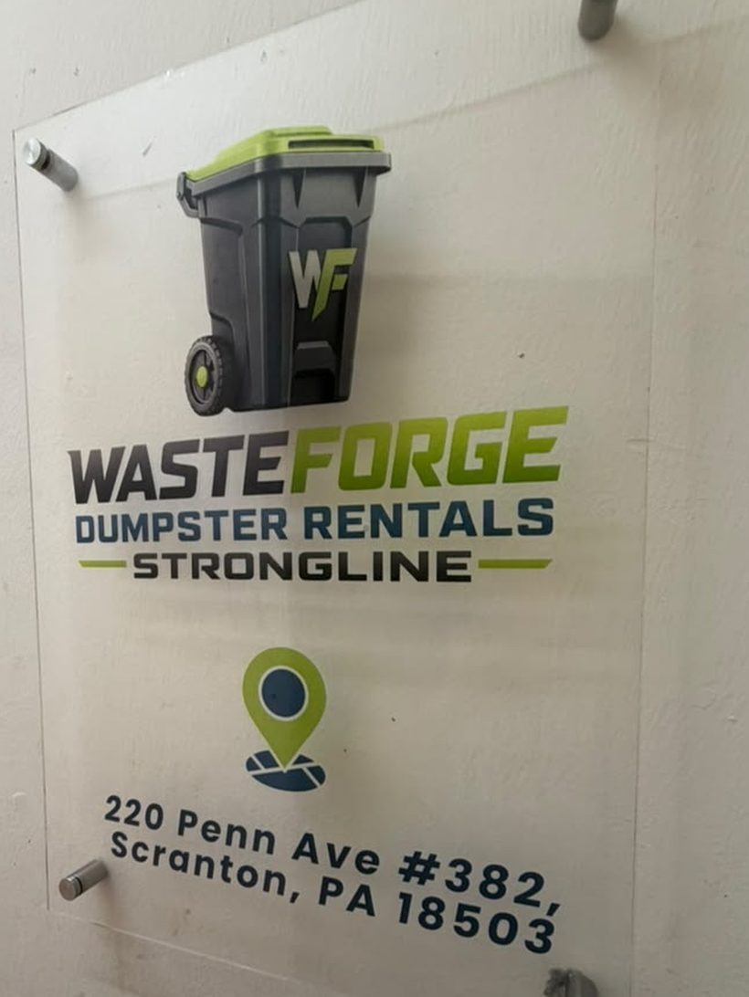 Office door sign showing the Wasteforge Dumpster Rentals Strongline logo and 220 Penn Ave #382
